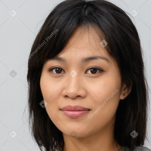 Joyful asian young-adult female with long  brown hair and brown eyes