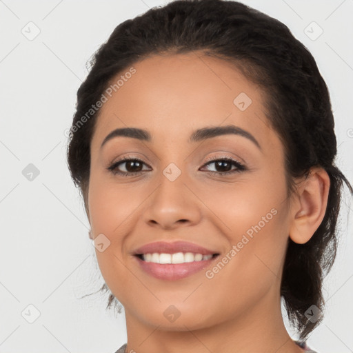 Joyful latino young-adult female with long  brown hair and brown eyes