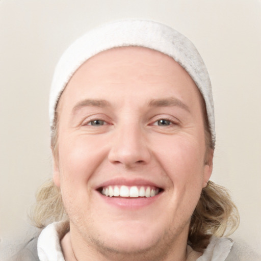 Joyful white young-adult male with short  brown hair and blue eyes