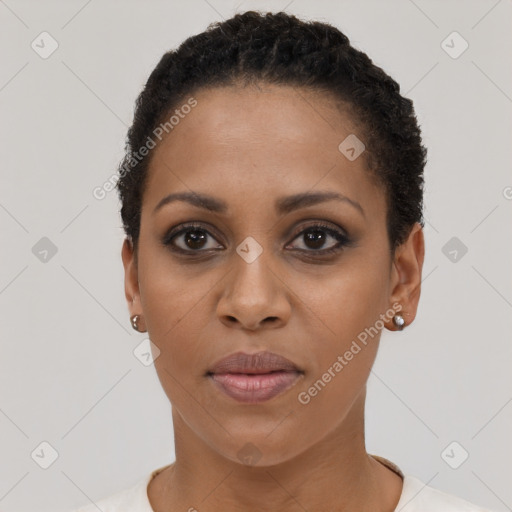 Joyful black young-adult female with short  black hair and brown eyes