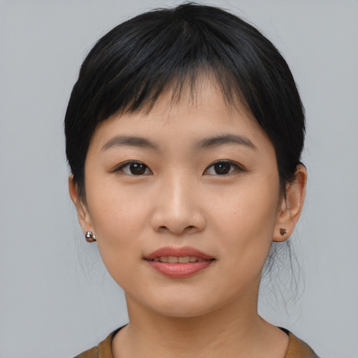 Joyful asian young-adult female with medium  black hair and brown eyes