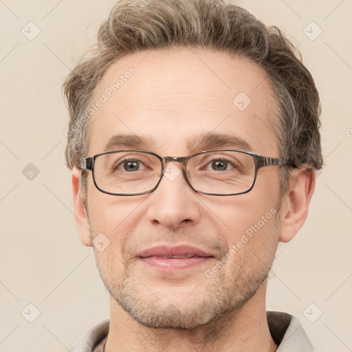 Joyful white adult male with short  brown hair and grey eyes