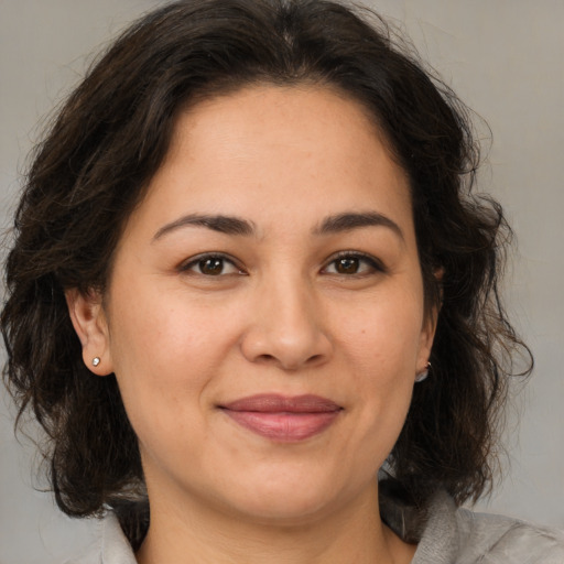 Joyful white adult female with medium  brown hair and brown eyes