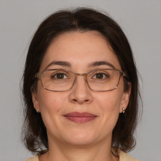 Joyful white adult female with medium  brown hair and grey eyes