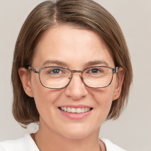 Joyful white adult female with medium  brown hair and blue eyes