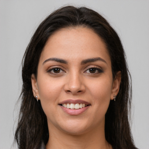 Joyful white young-adult female with long  brown hair and brown eyes