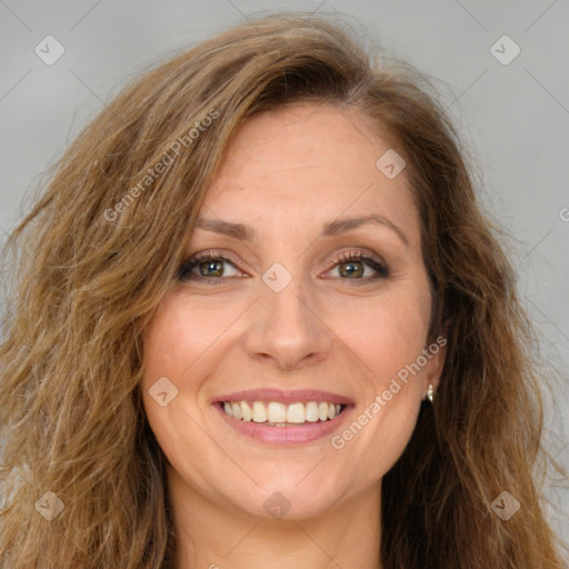 Joyful white adult female with long  brown hair and green eyes