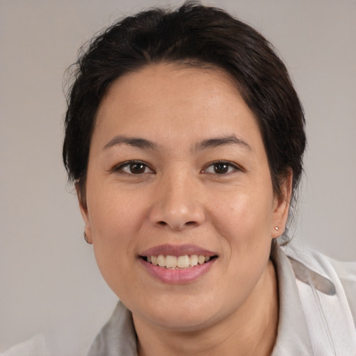 Joyful white adult female with medium  brown hair and brown eyes
