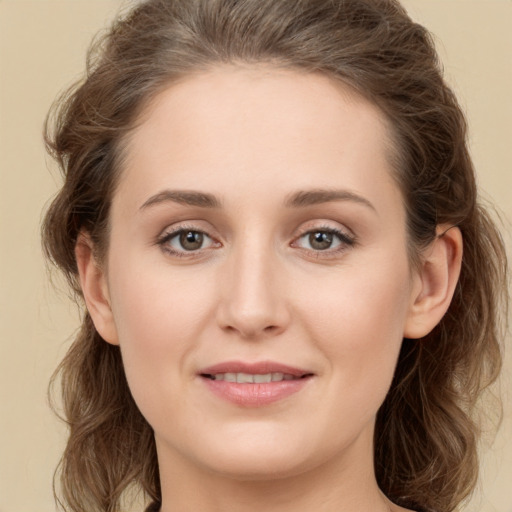 Joyful white young-adult female with long  brown hair and green eyes