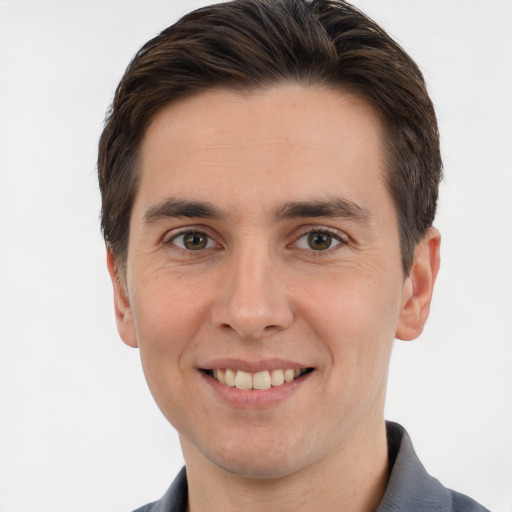 Joyful white young-adult male with short  brown hair and brown eyes