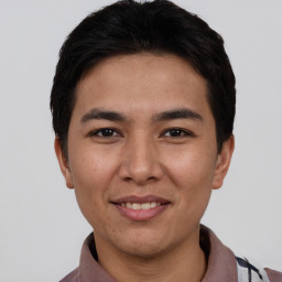 Joyful asian young-adult male with short  black hair and brown eyes