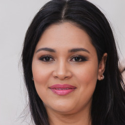 Joyful latino young-adult female with long  black hair and brown eyes