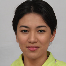 Joyful asian young-adult female with short  brown hair and brown eyes