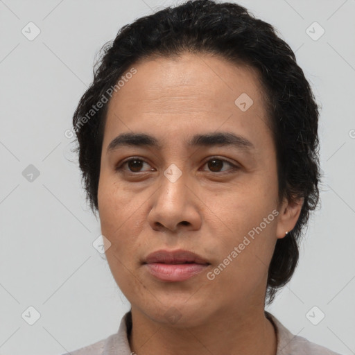 Joyful latino young-adult male with short  brown hair and brown eyes