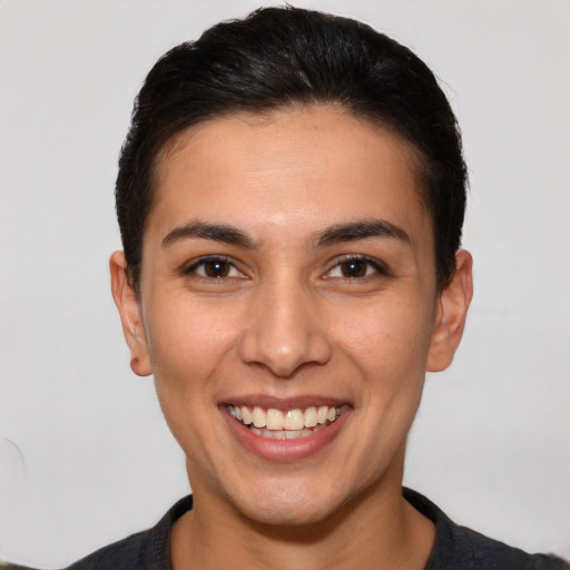 Joyful white young-adult female with short  brown hair and brown eyes