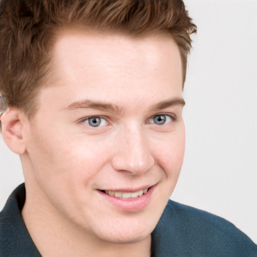 Joyful white young-adult male with short  brown hair and blue eyes