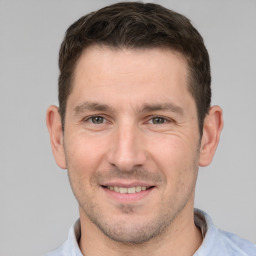 Joyful white adult male with short  brown hair and brown eyes