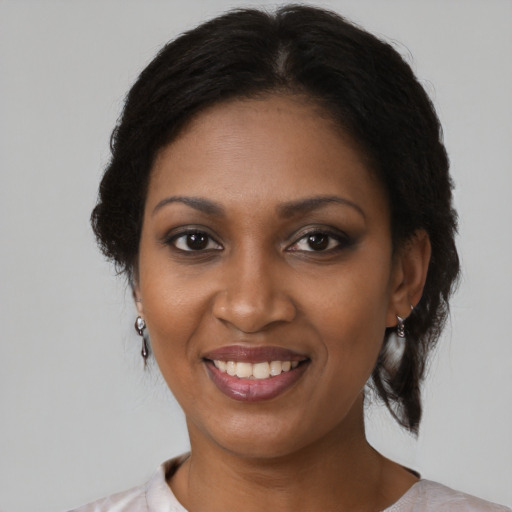 Joyful black young-adult female with medium  brown hair and brown eyes