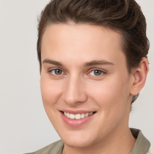 Joyful white young-adult female with short  brown hair and grey eyes