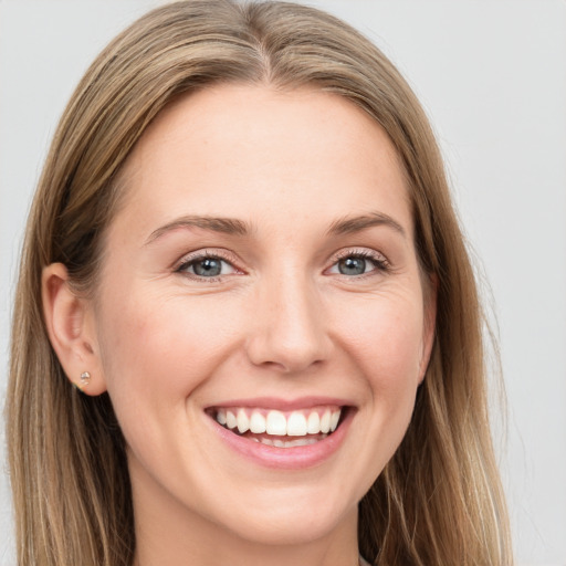 Joyful white young-adult female with long  brown hair and grey eyes