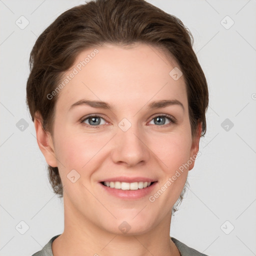 Joyful white young-adult female with short  brown hair and grey eyes