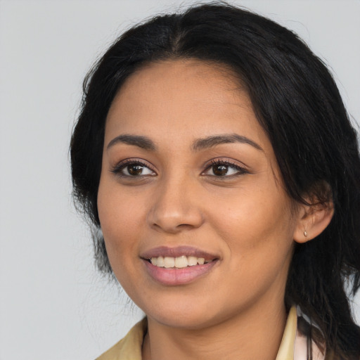 Joyful latino young-adult female with long  black hair and brown eyes