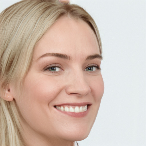 Joyful white young-adult female with long  brown hair and blue eyes