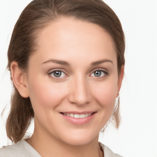 Joyful white young-adult female with medium  brown hair and grey eyes