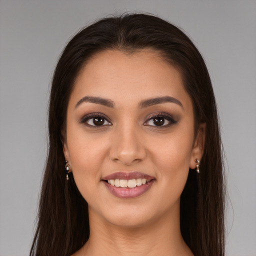 Joyful white young-adult female with long  brown hair and brown eyes