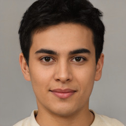 Joyful latino young-adult male with short  brown hair and brown eyes