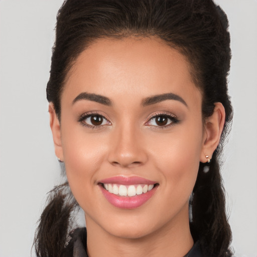 Joyful white young-adult female with long  brown hair and brown eyes