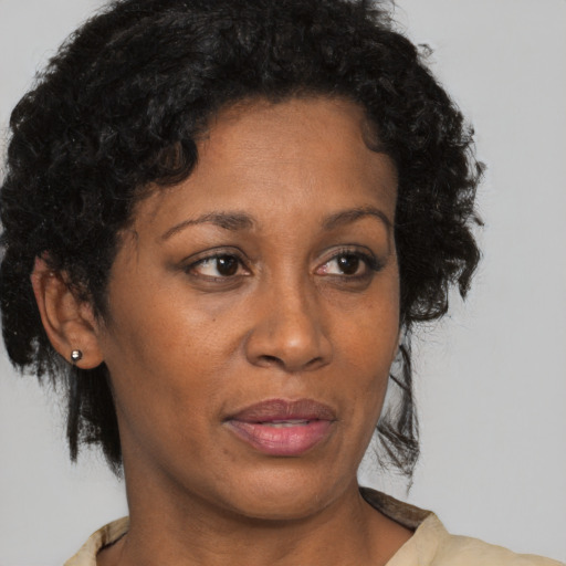 Joyful black adult female with short  brown hair and brown eyes