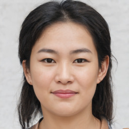 Joyful asian young-adult female with medium  brown hair and brown eyes