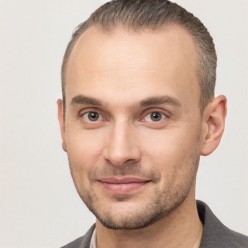 Joyful white adult male with short  brown hair and brown eyes