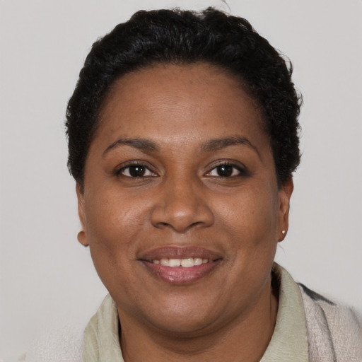 Joyful black young-adult female with short  brown hair and brown eyes