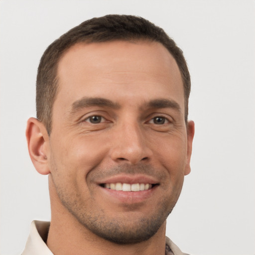 Joyful white young-adult male with short  brown hair and brown eyes