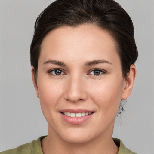 Joyful white young-adult female with medium  brown hair and brown eyes