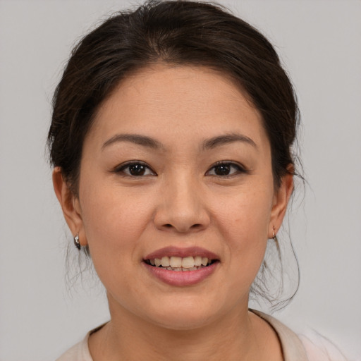 Joyful asian young-adult female with medium  brown hair and brown eyes