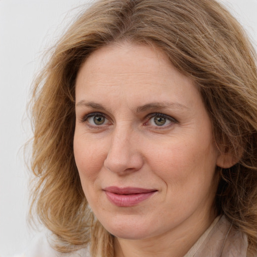 Joyful white adult female with long  brown hair and brown eyes