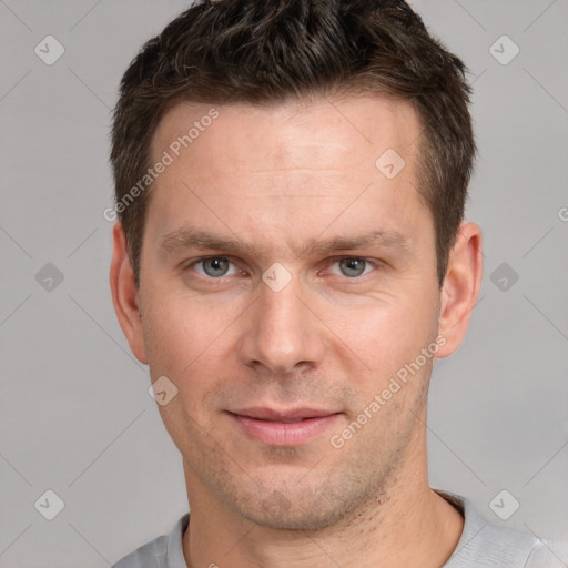 Joyful white adult male with short  brown hair and grey eyes