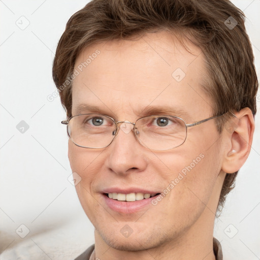 Joyful white adult male with short  brown hair and grey eyes