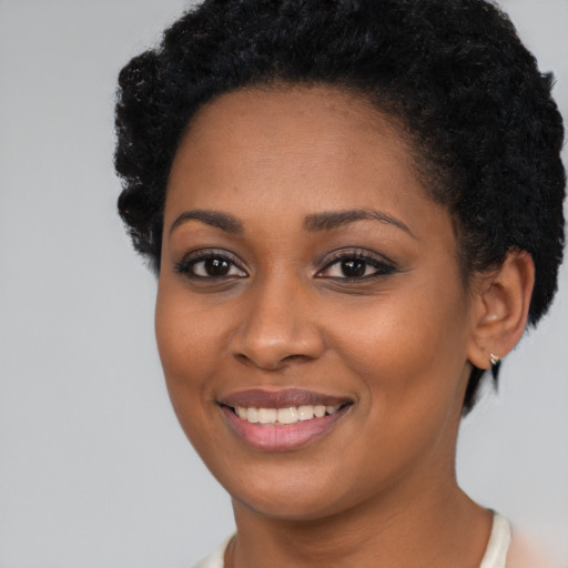 Joyful black young-adult female with short  brown hair and brown eyes