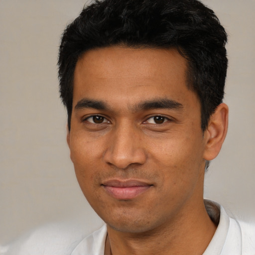 Joyful asian young-adult male with short  black hair and brown eyes