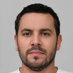 Neutral white young-adult male with short  black hair and brown eyes