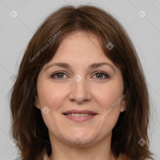 Joyful white adult female with medium  brown hair and grey eyes