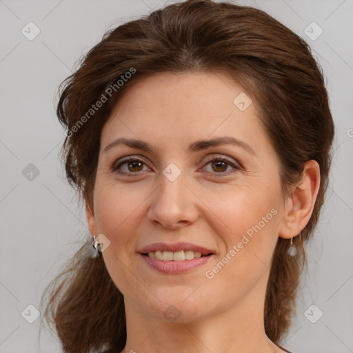 Joyful white adult female with medium  brown hair and brown eyes