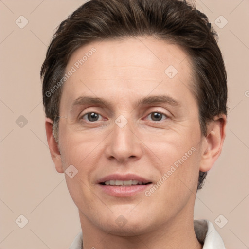 Joyful white adult male with short  brown hair and grey eyes