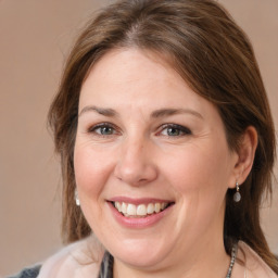 Joyful white adult female with medium  brown hair and brown eyes