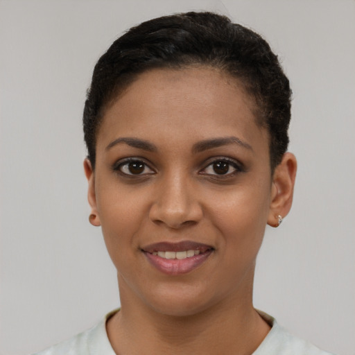 Joyful latino young-adult female with short  brown hair and brown eyes