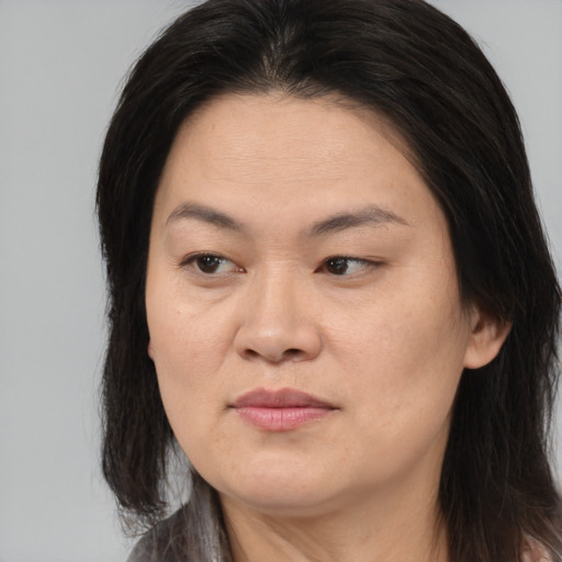 Joyful asian adult female with medium  brown hair and brown eyes